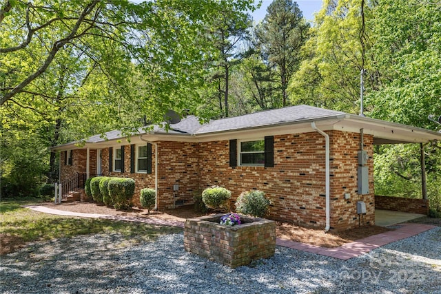 view of side of property featuring crawl space, a shingled roof, and brick siding