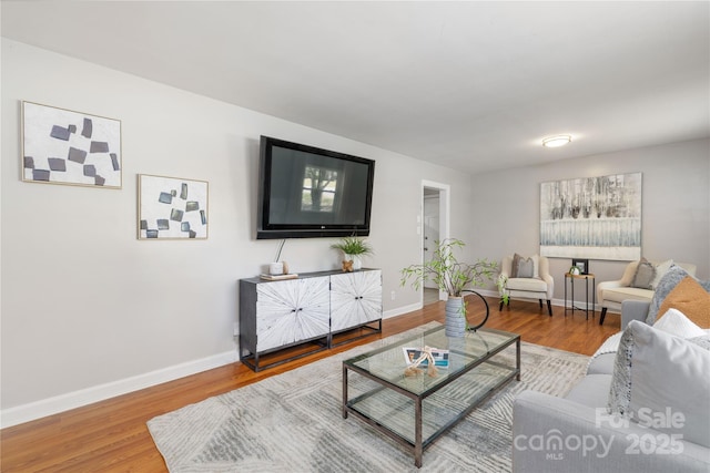 living area featuring wood finished floors and baseboards