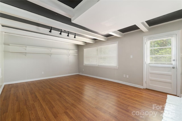 interior space featuring wood finished floors and beamed ceiling