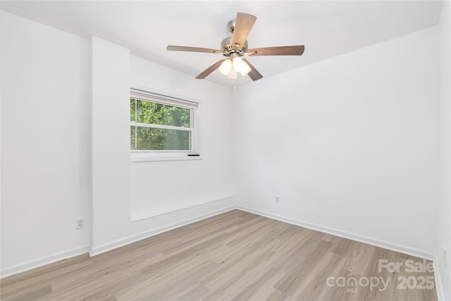 unfurnished room featuring baseboards, a ceiling fan, and light wood-type flooring