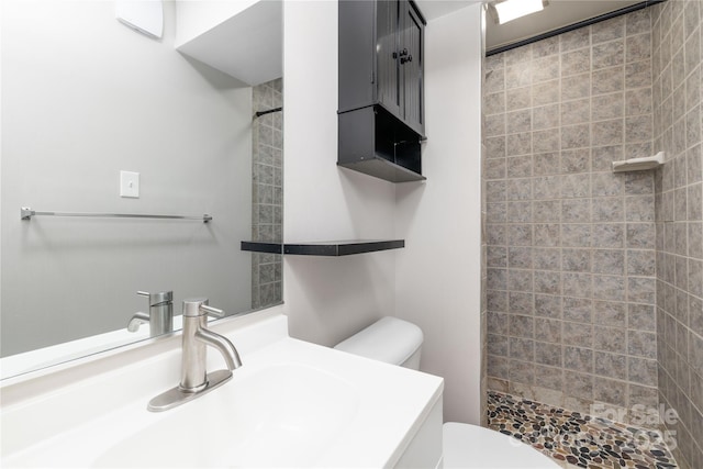 bathroom featuring a stall shower, vanity, and toilet