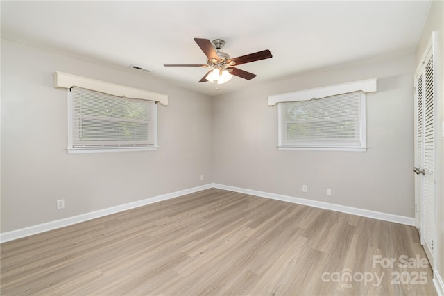 unfurnished bedroom featuring visible vents, baseboards, a ceiling fan, wood finished floors, and a closet