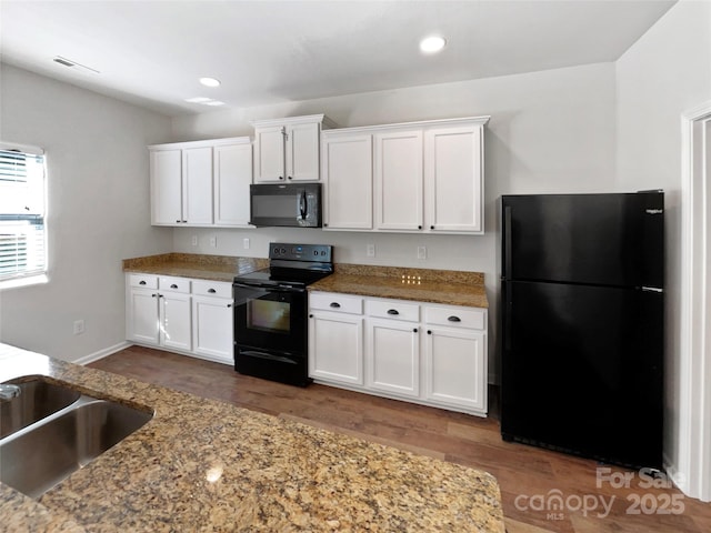 805 Gunnar Dr, Gastonia, NC 28054 - kitchen featuring dark wood finished floors, white cabinetry, black appliances, recessed lighting, and stone counters