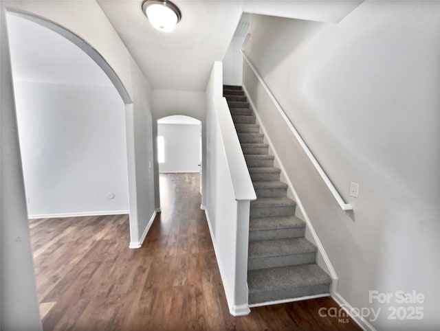 805 Gunnar Dr, Gastonia, NC 28054 - staircase with arched walkways, baseboards, and wood finished floors