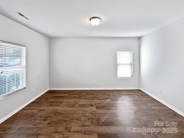 805 Gunnar Dr, Gastonia, NC 28054 - unfurnished room with dark wood finished floors, visible vents, baseboards, and a healthy amount of sunlight