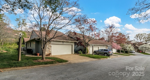 104 Parkway Ct Unit 1, Asheville, NC 28803 - view of front facade featuring an attached garage, concrete driveway, a front yard, and a residential view