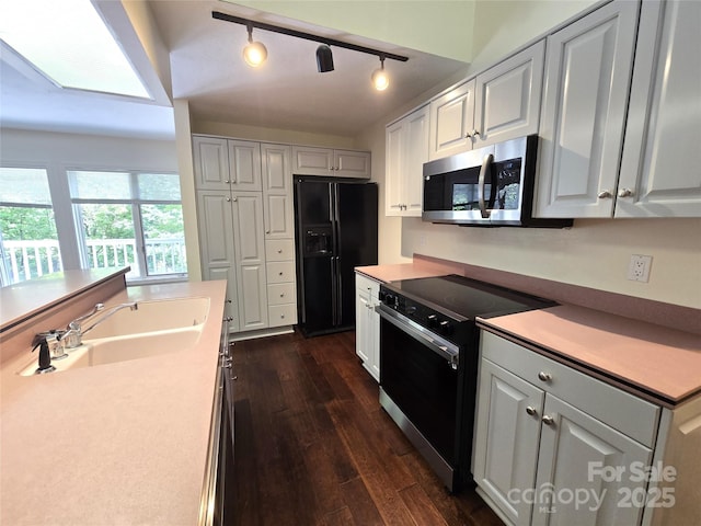 124 Cardinal Rd, Lake Lure, NC 28746 - kitchen with black appliances, a sink, dark wood-style floors, white cabinetry, and light countertops