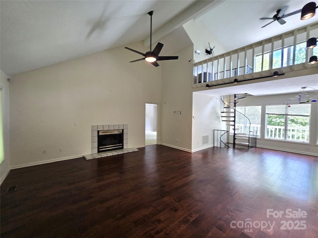 124 Cardinal Rd, Lake Lure, NC 28746 - unfurnished living room featuring ceiling fan, wood finished floors, high vaulted ceiling, a tile fireplace, and baseboards