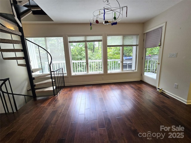 124 Cardinal Rd, Lake Lure, NC 28746 - unfurnished living room featuring dark wood-style floors, baseboards, and stairway