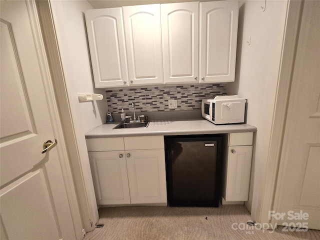124 Cardinal Rd, Lake Lure, NC 28746 - kitchen featuring a sink, white microwave, fridge, white cabinets, and backsplash