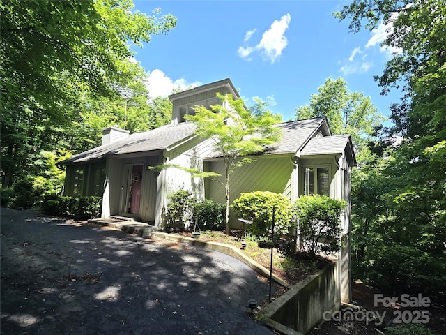 124 Cardinal Rd, Lake Lure, NC 28746 - mid-century modern home with roof with shingles and a chimney