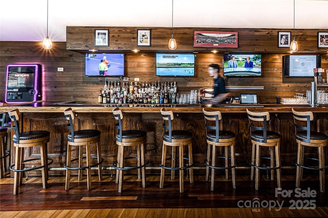 124 Cardinal Rd, Lake Lure, NC 28746 - indoor wet bar featuring wooden walls, decorative light fixtures, and hardwood / wood-style flooring
