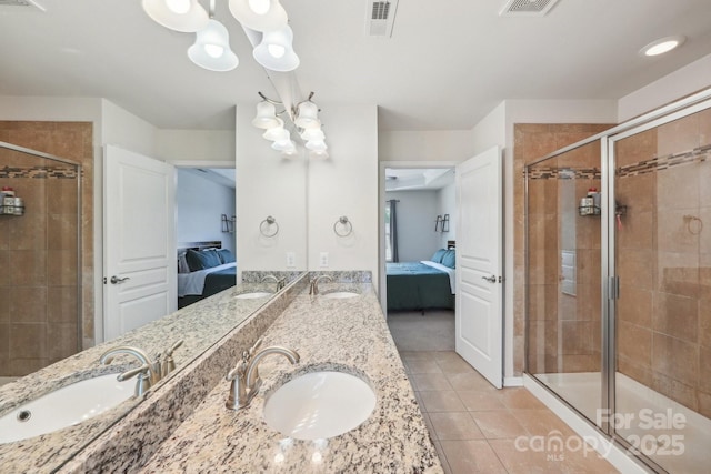 5037 Nighthawk Dr, Fort Mill, SC 29707 - ensuite bathroom featuring a chandelier, a stall shower, tile patterned floors, and double vanity