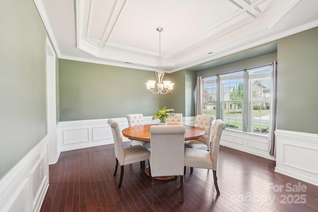 5037 Nighthawk Dr, Fort Mill, SC 29707 - dining area featuring a chandelier, crown molding, a decorative wall, dark wood-style flooring, and wainscoting