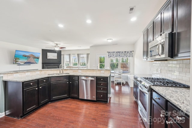 5037 Nighthawk Dr, Fort Mill, SC 29707 - kitchen featuring appliances with stainless steel finishes, a sink, a ceiling fan, backsplash, and recessed lighting
