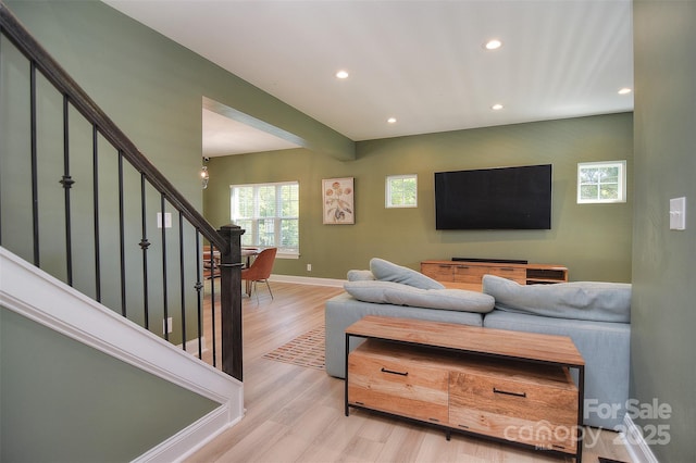 living area featuring stairway, baseboards, recessed lighting, and wood finished floors