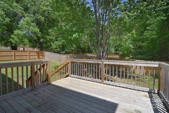 deck with a fenced backyard