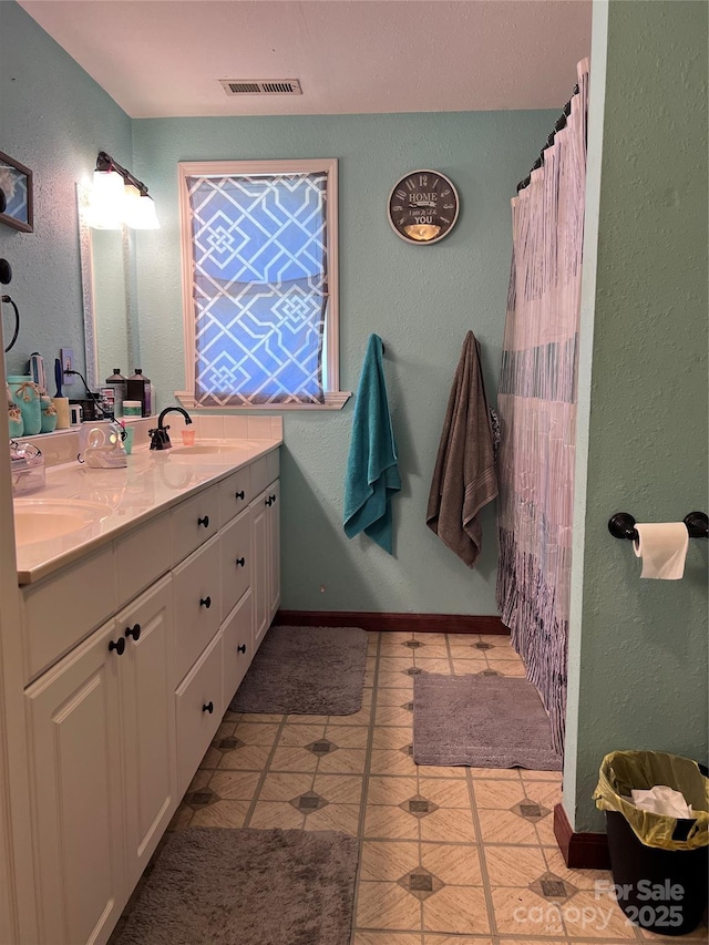 541 Pilgrim Rd, Ellenboro, NC 28040 - full bathroom with a sink, visible vents, double vanity, and a textured wall