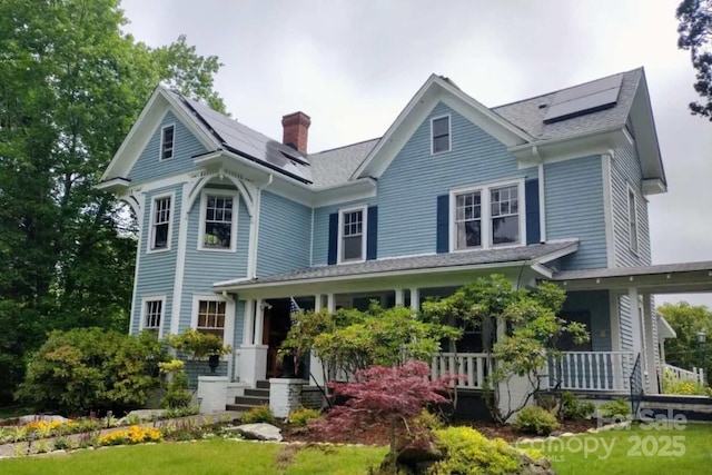 88 S Main St, Weaverville, NC 28787 - victorian-style house with a chimney, covered porch, and roof mounted solar panels