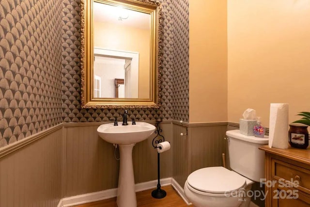 88 S Main St, Weaverville, NC 28787 - half bathroom with toilet, wainscoting, wood finished floors, and wallpapered walls