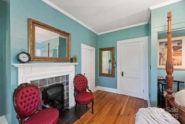88 S Main St, Weaverville, NC 28787 - living area with crown molding, a tile fireplace, baseboards, and hardwood / wood-style flooring