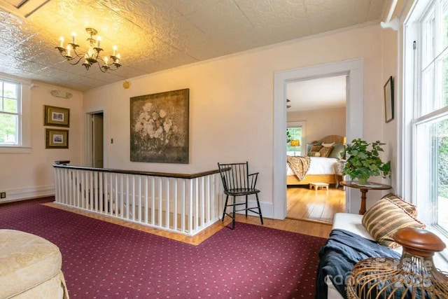 88 S Main St, Weaverville, NC 28787 - living room featuring a notable chandelier, baseboards, ornamental molding, and wood finished floors