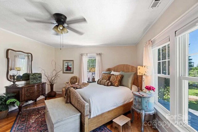 88 S Main St, Weaverville, NC 28787 - bedroom featuring wood finished floors, ceiling fan, ornamental molding, and visible vents