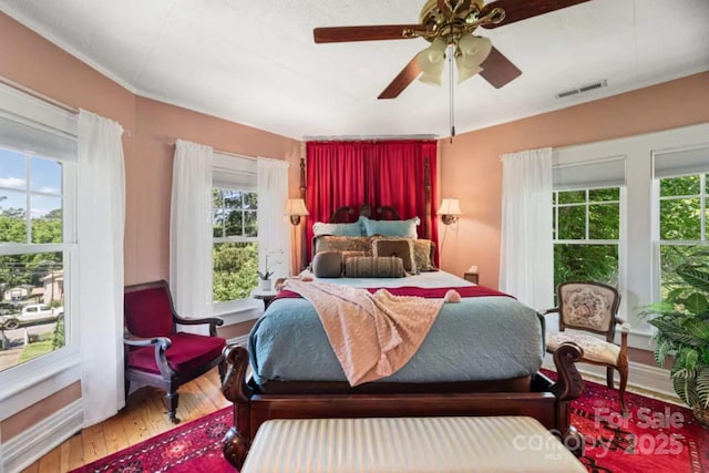 88 S Main St, Weaverville, NC 28787 - bedroom featuring hardwood / wood-style floors, ceiling fan, multiple windows, and visible vents