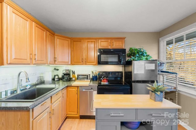 88 S Main St, Weaverville, NC 28787 - kitchen with a sink, gray cabinets, light wood-type flooring, and black appliances
