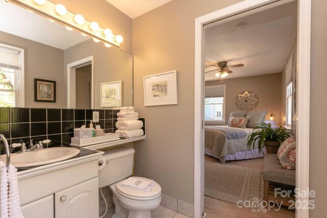 88 S Main St, Weaverville, NC 28787 - bathroom featuring toilet, ceiling fan, connected bathroom, and a wealth of natural light