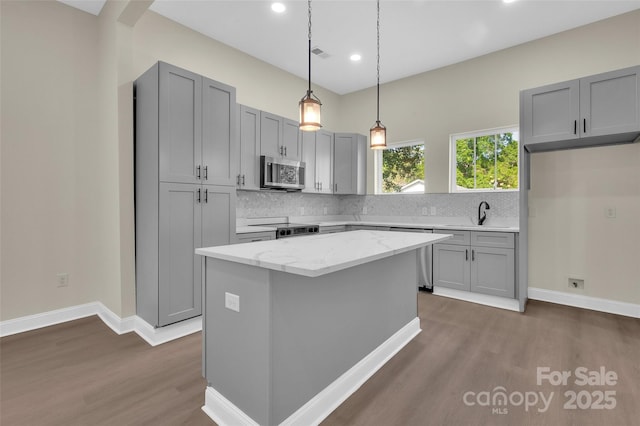 126 Hemphill Ave, Chester, SC 29706 - kitchen featuring appliances with stainless steel finishes, gray cabinets, dark wood-style flooring, tasteful backsplash, and recessed lighting