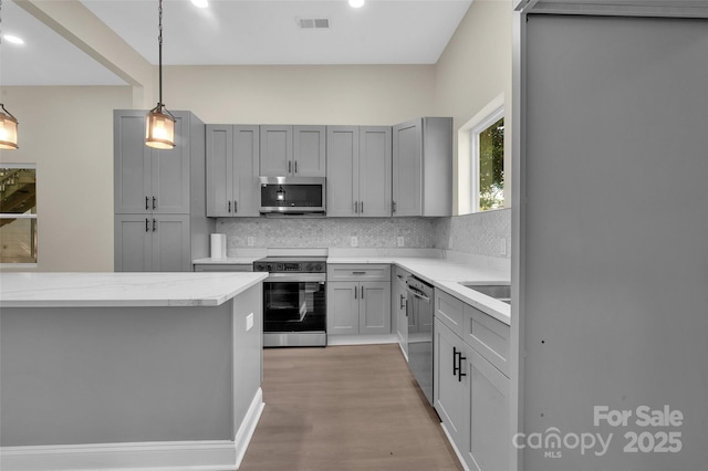 126 Hemphill Ave, Chester, SC 29706 - kitchen with stainless steel appliances, tasteful backsplash, gray cabinets, pendant lighting, and recessed lighting