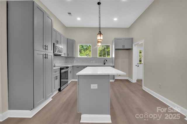 126 Hemphill Ave, Chester, SC 29706 - kitchen featuring stainless steel appliances, gray cabinets, light wood finished floors, tasteful backsplash, and recessed lighting