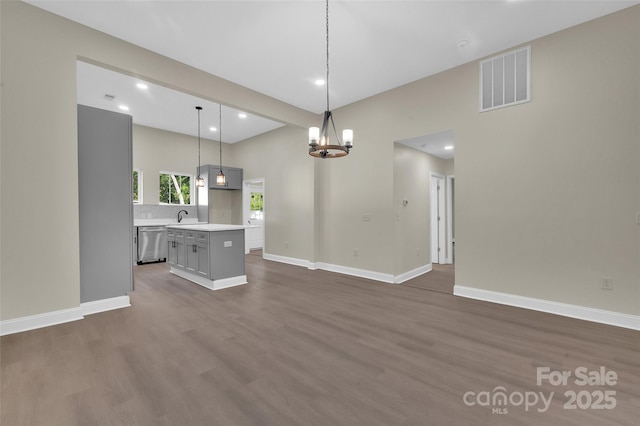 126 Hemphill Ave, Chester, SC 29706 - unfurnished living room featuring dark wood-type flooring, baseboards, recessed lighting, a chandelier, and a sink