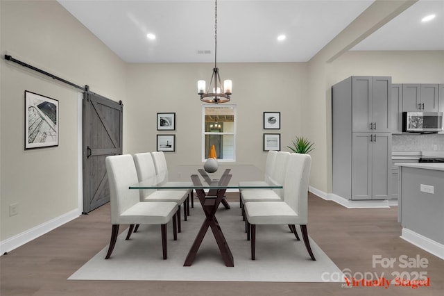 126 Hemphill Ave, Chester, SC 29706 - dining area with a barn door, wood finished floors, a chandelier, baseboards, and recessed lighting