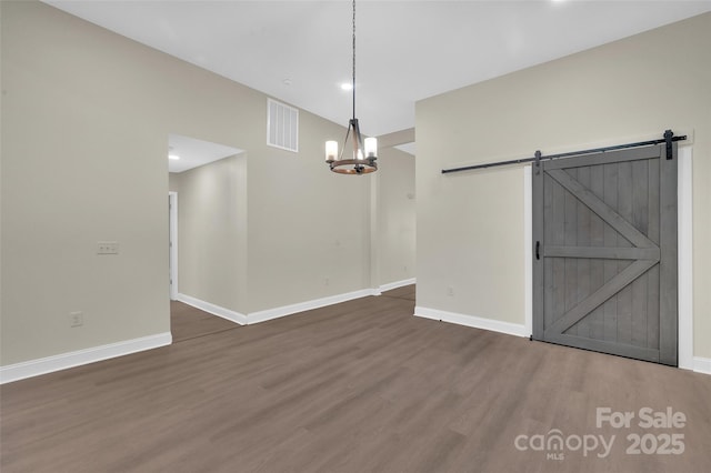126 Hemphill Ave, Chester, SC 29706 - unfurnished dining area with wood finished floors, baseboards, a barn door, a chandelier, and recessed lighting