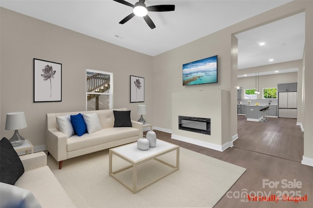 126 Hemphill Ave, Chester, SC 29706 - living room featuring a ceiling fan, wood finished floors, baseboards, recessed lighting, and a glass covered fireplace