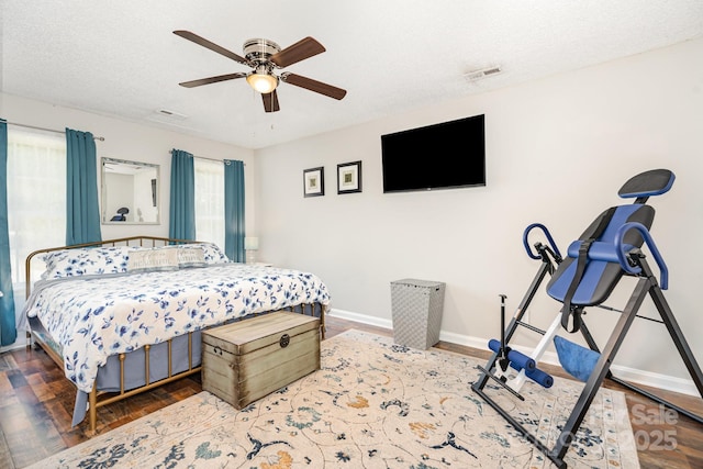 bedroom with baseboards, wood finished floors, and ceiling fan