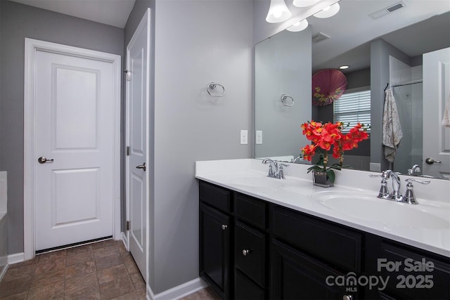 7397 Mill Ruins Ave SW, Concord, NC 28025 - bathroom with double vanity, stone finish floors, and an enclosed shower