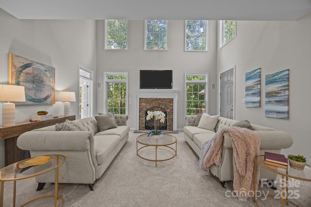 263 Fernbrook Dr, Mooresville, NC 28117 - living room featuring plenty of natural light, a towering ceiling, a fireplace, and carpet flooring