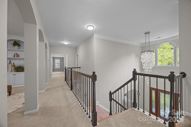 263 Fernbrook Dr, Mooresville, NC 28117 - hall featuring an upstairs landing, arched walkways, baseboards, carpet flooring, and ornamental molding