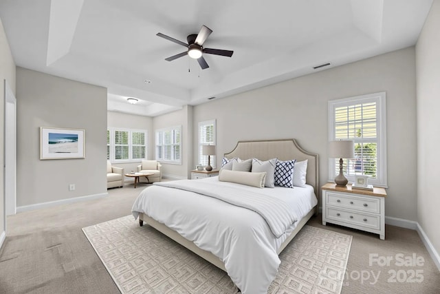 263 Fernbrook Dr, Mooresville, NC 28117 - bedroom featuring a tray ceiling, light colored carpet, and multiple windows