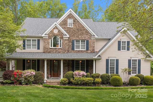 263 Fernbrook Dr, Mooresville, NC 28117 - traditional-style house with a shingled roof, a front yard, stone siding, and covered porch