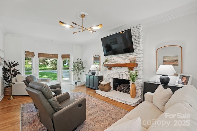 902 Hoke Trl, Cramerton, NC 28032 - living room with a stone fireplace, crown molding, wood finished floors, and a chandelier