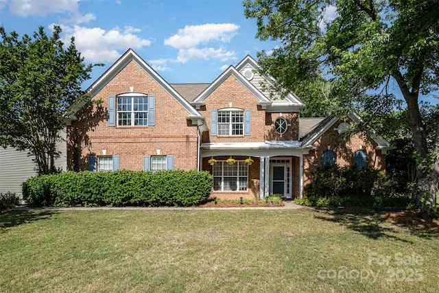 traditional home with brick siding and a front yard
