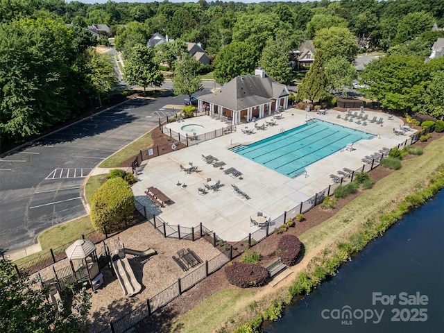 aerial view of a pool area and a large body of water