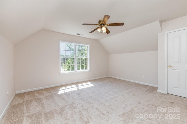 additional living space featuring lofted ceiling, a ceiling fan, carpet, and baseboards