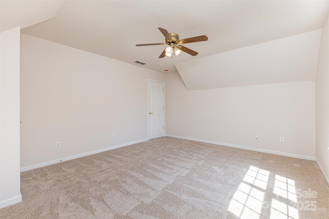 additional living space featuring vaulted ceiling, a ceiling fan, carpet, and baseboards