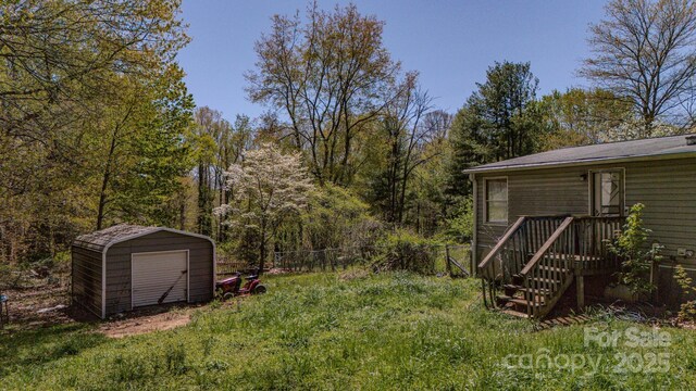 19 Blackberry Ln Unit 42, Candler, NC 28715 - view of yard featuring fence, an outbuilding, a garage, and a shed