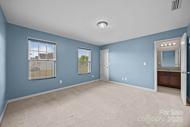 unfurnished bedroom featuring visible vents, light carpet, baseboards, and connected bathroom